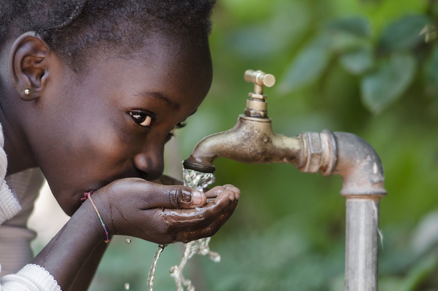 African girl drinking water